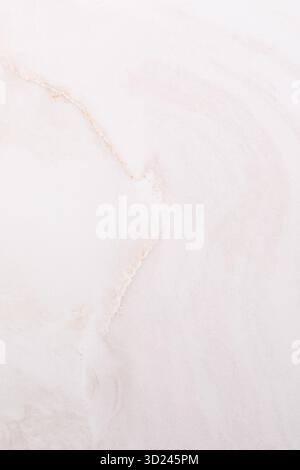 Light pink marble texture with soft swirls and subtle lines in natural patterns Stock Photo