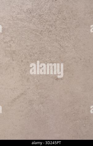Textured surface with subtle variations in color and pattern reflecting a natural stone appearance in warm tones Stock Photo