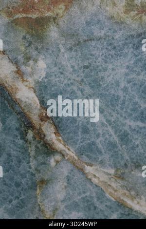 Natural stone surface featuring a stunning blue and white marble pattern with unique veins and textures Stock Photo