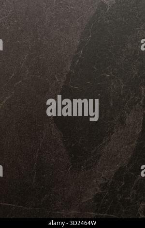 Dark textured surface with subtle patterns showcasing natural stone characteristics and intricate design elements Stock Photo