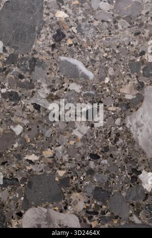 Unique texture of polished concrete showcasing mineral and stone fragments under natural light Stock Photo