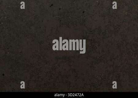 Dark textured surface featuring subtle patterns and variations in tone suitable for minimalist design and creative backgrounds Stock Photo
