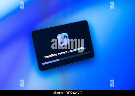 Poznan, Poland - September 18, 2025: Close-up of a software installation window displaying 'Installing system components...' with a hammer icon on a v Stock Photo