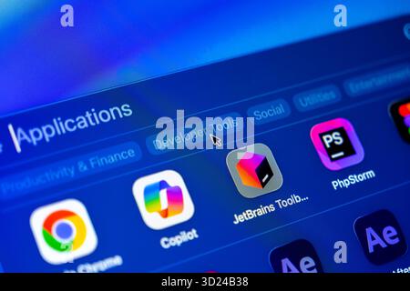 Poznan, Poland - September 18, 2025: Close-up of a vibrant blue digital screen displaying an applications menu, with a mouse cursor selecting Develope Stock Photo