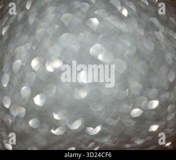Abstract circular light bokeh with sparkling white and silver tones in blurred Stock Photo