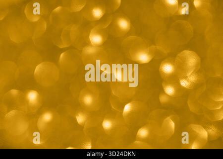 Golden bokeh background with soft circular light patterns creating a warm Stock Photo