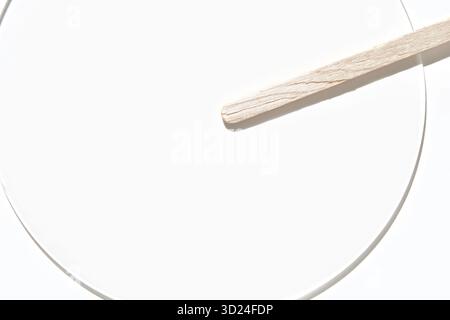 Minimalist wood and white aesthetic with light shadow play on circular geometric Stock Photo