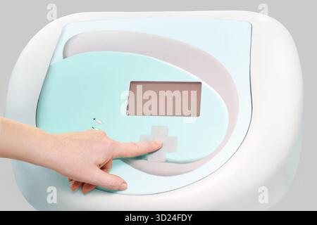 Futuristic medical device interface with human hand pressing touch screen button Stock Photo