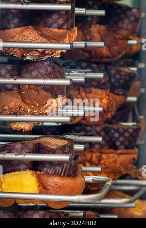Traditional colombe pasquali cooling upside down to preserve volume and texture. Italy. Stock Photo