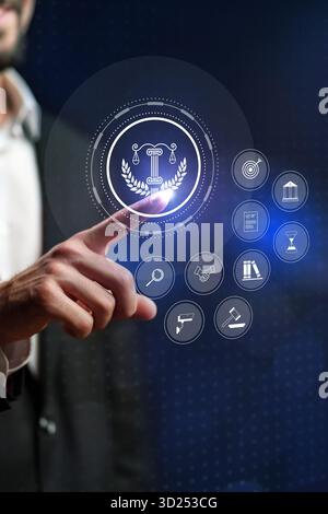 Legal technology in action as a man interacts with a digital interface showing law symbols Stock Photo