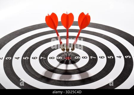 Target hit in the center by arrows. Dart board with arrows isolated on white Stock Photo
