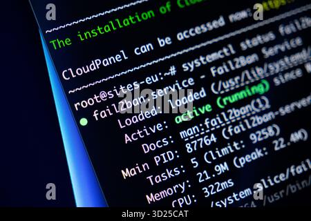 Poznan, Poland - September 24, 2025: Close-up view of programming code on a screen, detailing fail2ban.service active status and CloudPanel installati Stock Photo