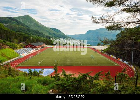 Måløy Stadion in Måløy, Norway – modern sports facility surrounded by coastal landscape, mountains and fjord views on Norway’s western coast Stock Photo
