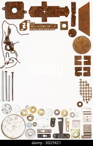 A group of various old and new bits and pieces arranged on white. Old rusty nuts, bolts, nails and other parts flay lay on white background. Stock Photo