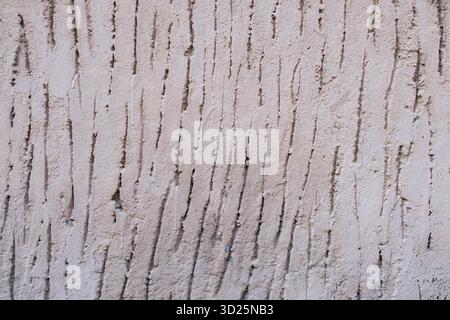 Close-up of a textured wall with vertical grooves and rough patterns Stock Photo