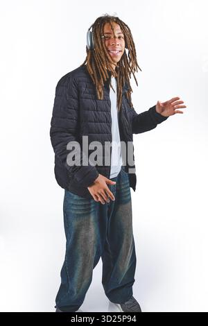 Black man with dreadlocks listening music on headphones Stock Photo