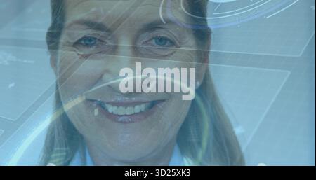 Smiling woman wearing blue shirt interacting with interface in lab, with circular targets, readouts Stock Photo