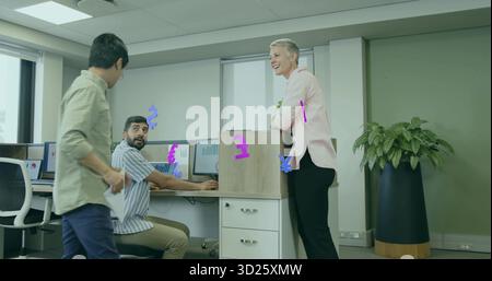 Gathering office coworkers discussing papers at cubicle in open-plan office, with dual monitors Stock Photo