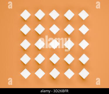 White square sugar cubes arranged in rows on salmon orange background Stock Photo
