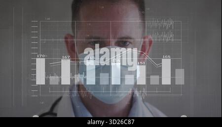 Standing male doctor wearing white coat, mask and stethoscope at gray wall, with digital interface Stock Photo