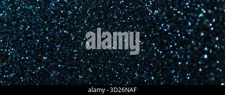 Dark blue sparkling background from small sequins, macro. Shiny navy glitter backdrop for Christmas or New Year. Stock Photo