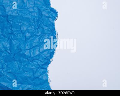 Crumpled and torn blue paper on a white background. Stock Photo