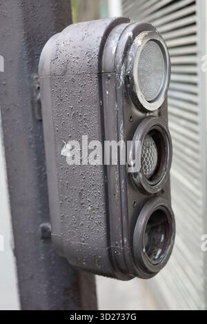 Weathered metal traffic light in France with no lights on Stock Photo