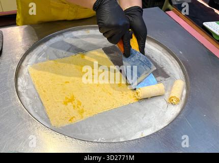 Making traditional Thai ice cream on a cold plate freezer. Thai street food. Dessert. Stock Photo