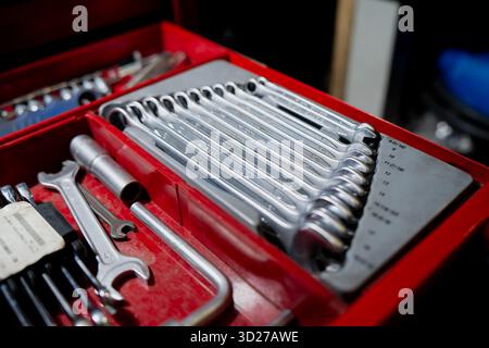 Organized mechanic toolset with metal wrenches and sockets in red toolbox representing maintenance, workshop repair and professional hand tool equipme Stock Photo
