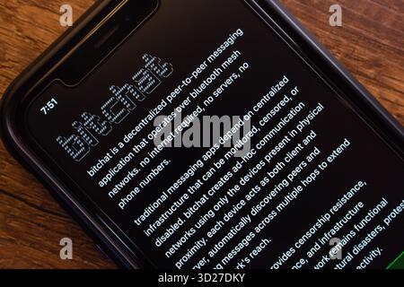 A smartphone displaying the Bitchat website. Bitchat is a peer-to-peer messaging app using Bluetooth mesh, without internet or central servers. Stock Photo