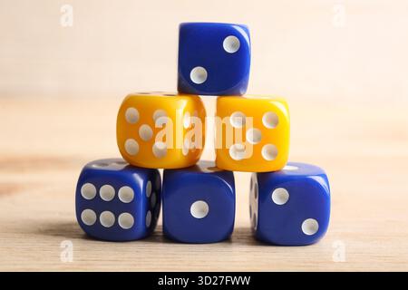 Stack of different game dices on wooden background Stock Photo