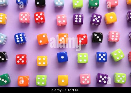 Colorful game dices on lilac background Stock Photo
