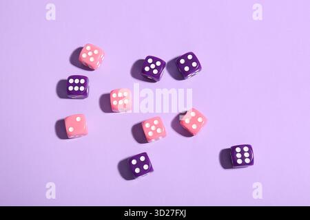 Different game dices on lilac background Stock Photo
