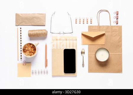Composition with mobile phone, packaging items and delivery paper bag on white background Stock Photo
