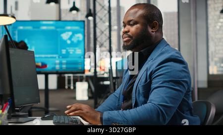 Close up of secretary pushing a trolley cart with papers and archived stack of files, bringing documents to a colleague and ensuring efficient resources distribution. Productivity tasks. Camera B. Stock Photo