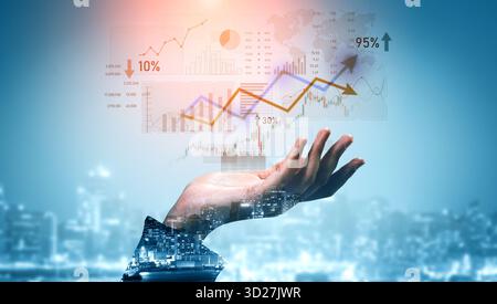 A hand reaches towards dynamic digital graphs showcasing financial growth and analytics. This image represents the intersection of technology and busi Stock Photo