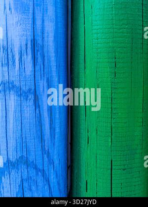 Close-up of the cracks and texture of two blue and green wooden planks. Stock Photo