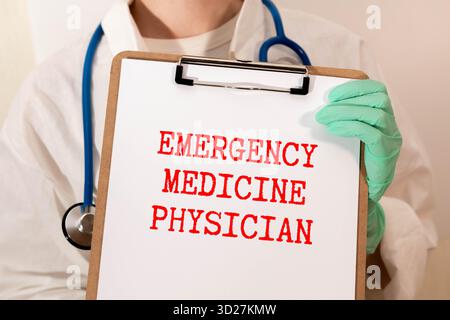 Asian Indian man or male physician or doctor wearing stethoscope and apron holding report file in hand and giving consultation to a smiling female or Stock Photo