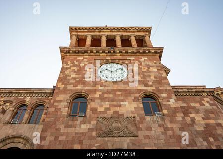 Yerevan, Armenia 10.16.2025. A clock tower with a large clock face and a small clock on the side. The clock face is white and has Roman numerals. The Stock Photo