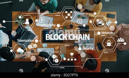 Innovative Blockchain Technology Concepts in a Collaborative Workspace with Diverse Professionals Engaging in Discussion and Analysis. Amity Stock Photo