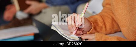 Young Adult Woman Taking Notes during Educational Seminar Indoors Stock Photo