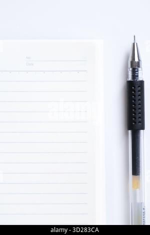 Close-up of blank notebook and pen isolated on white background Stock Photo