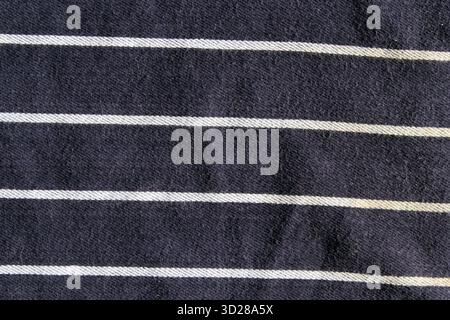 Close-up of navy blue fabric with horizontal white stripes abstract textured background Stock Photo