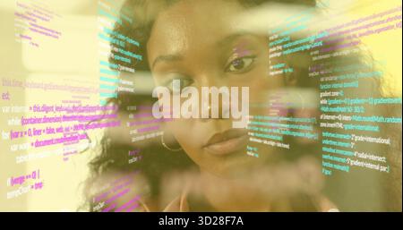 Analyzing software developer reviewing transparent display in tech office, with multicolored code Stock Photo