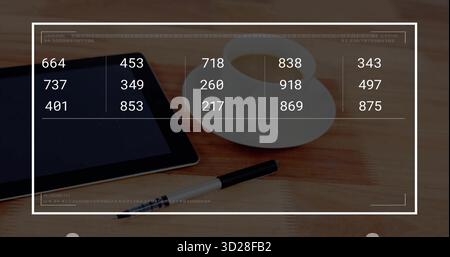 Displaying black tablet showing numeric overlay on wood table, coffee cup, saucer, pen, copy space Stock Photo