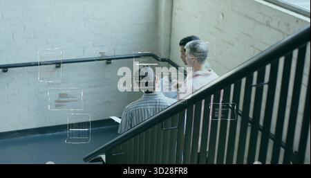 Collaborating developers viewing digital code overlays in office stairwell with tablet and railing Stock Photo