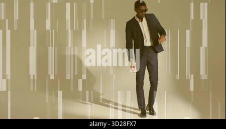 Posing mid adult man wearing dark suit and sunglasses leaning in studio, with glitch effect lights Stock Photo