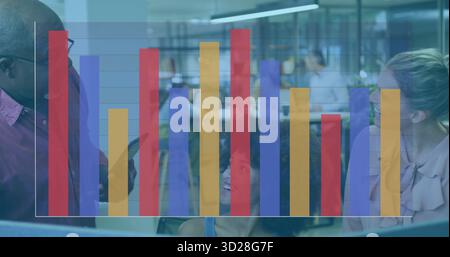 Reviewing data team consulting monitor in open office, with keyboard, bar chart overlay Stock Photo