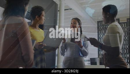 Discussing team projects using grid overlay in modern office, with laptop tablet smartphone folder Stock Photo