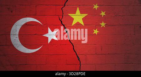 Cracked cinder block wall painted with a Turkish flag on the left and a Chinese flag on the right. Stock Photo